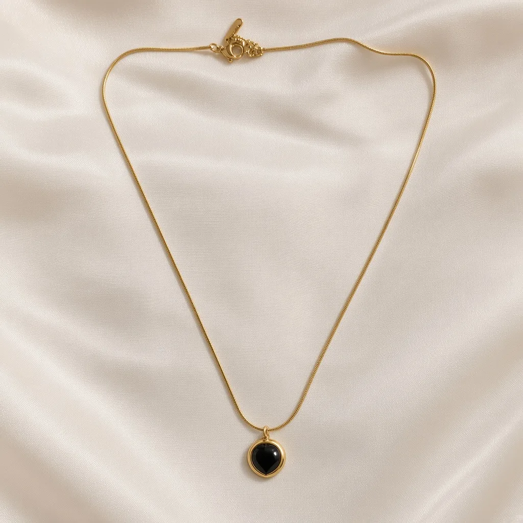 Gold snake chain with a black onyx heart pendant — 18k gold plated anti-tarnish necklace by The Luxe Jewels