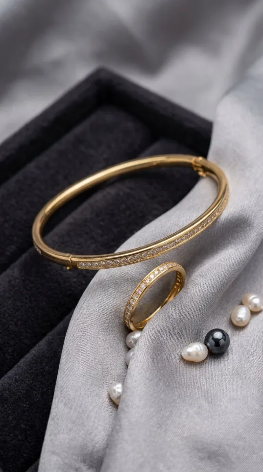 Gold pavé crystal bangle and ring set with continuous stone line on fabric