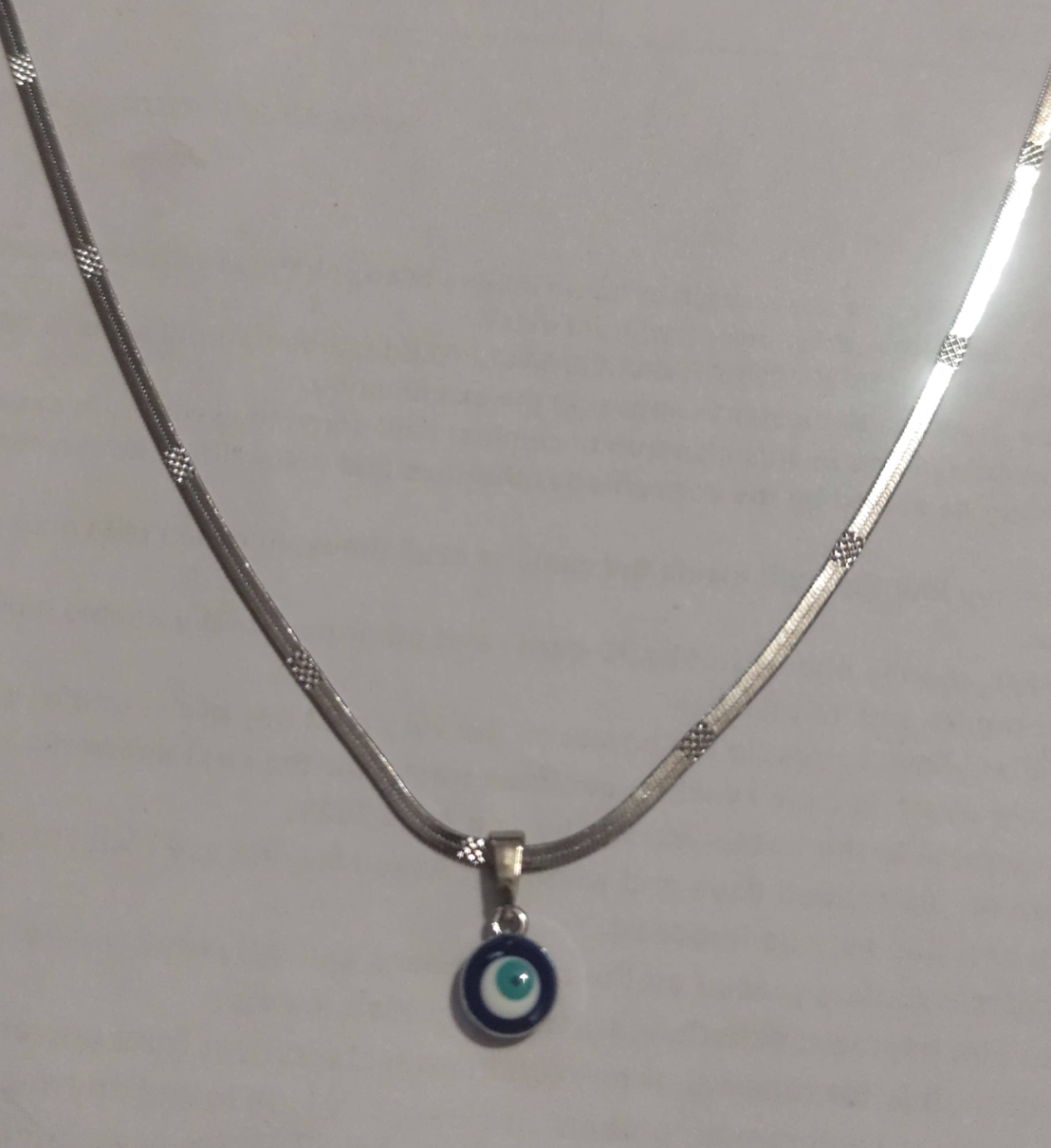 Silver textured snake chain necklace with evil eye disc pendant