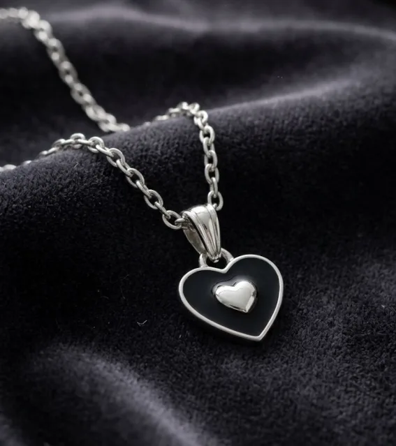 Black enamel heart pendant necklace with silver heart accent on silver chain