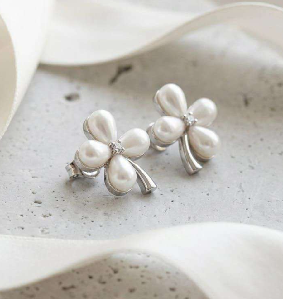 Silver-tone clover stud earrings with faux pearl petals and cubic zirconia center