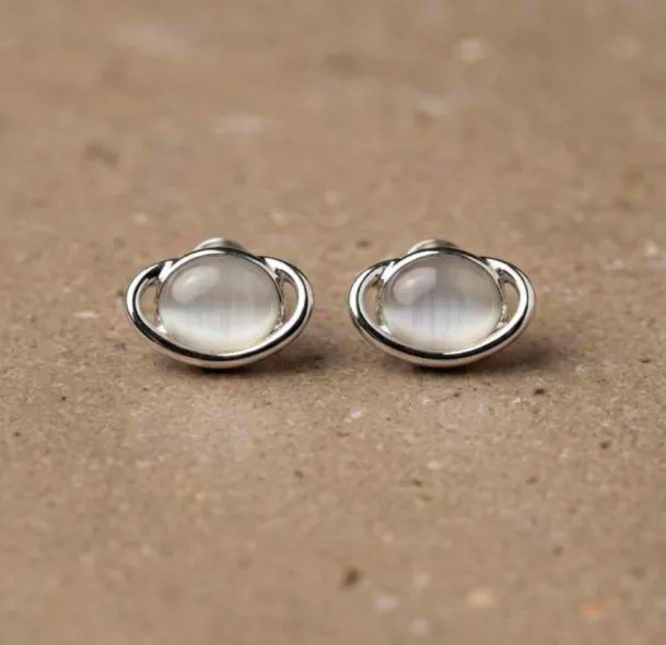 Silver-tone oval stud earrings with cat's-eye moonstone cabochon and swirl ring frame