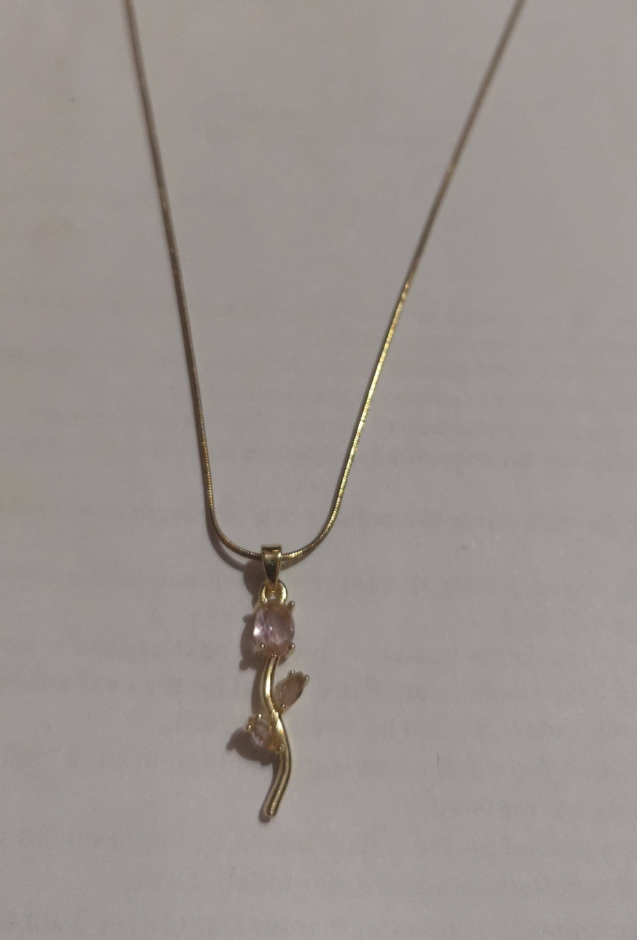 Gold branch pendant necklace with pink crystal accents