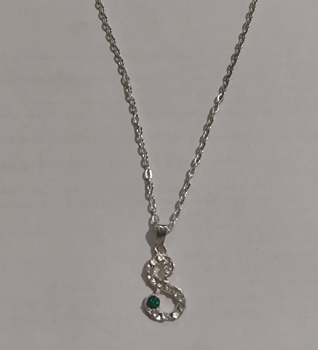 Silver S-shaped pendant necklace with pave crystals and emerald green stone