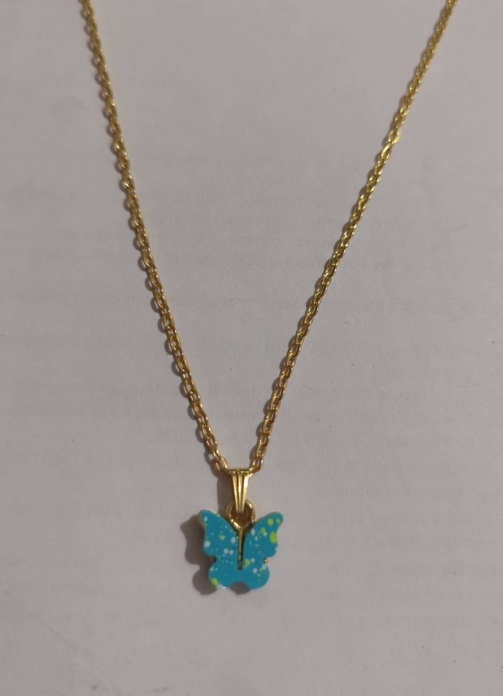 Gold-tone chain necklace with turquoise enamel butterfly pendant