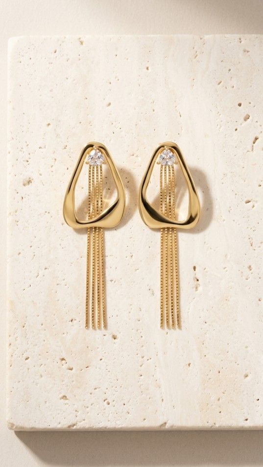 Gold geometric tassel earrings with sparkling stone and cascading chain drops, elegant statement jewelry for women