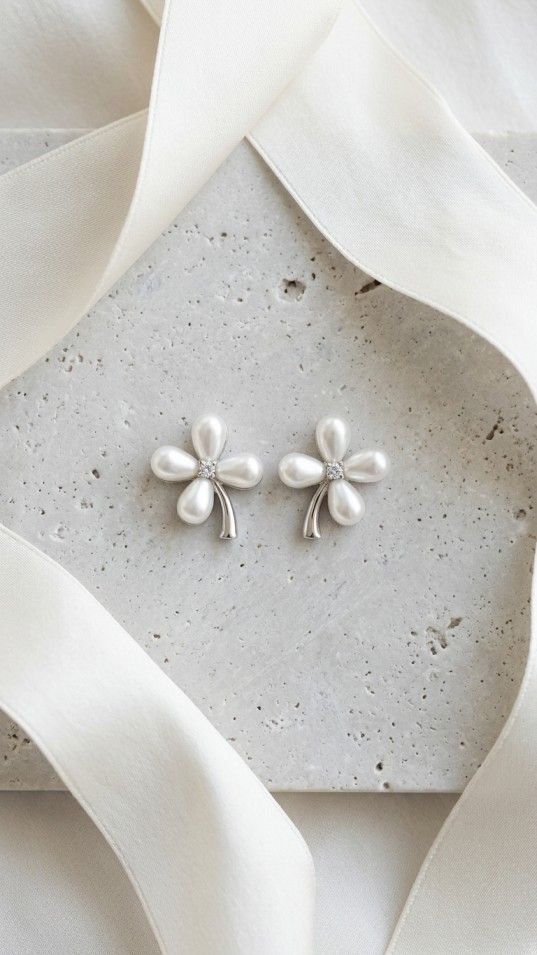 Elegant pearl flower stud earrings with teardrop-shaped petals and a sparkling center, minimal and stylish jewelry for women